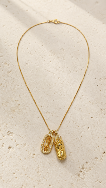 Aurone Pixiu Demon-Subduing Amulet Pendant necklace laid flat in a minimalist stone scene