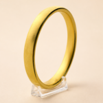 Aurone Tire Tread Bangle centered on a transparent acrylic jewelry stand