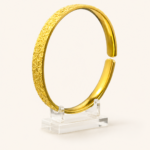 Aurone Sakura Crushed Ice Bangle centered on a transparent acrylic jewelry stand