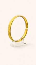 Aurone Sakura Crushed Ice Bangle centered on a transparent acrylic jewelry stand