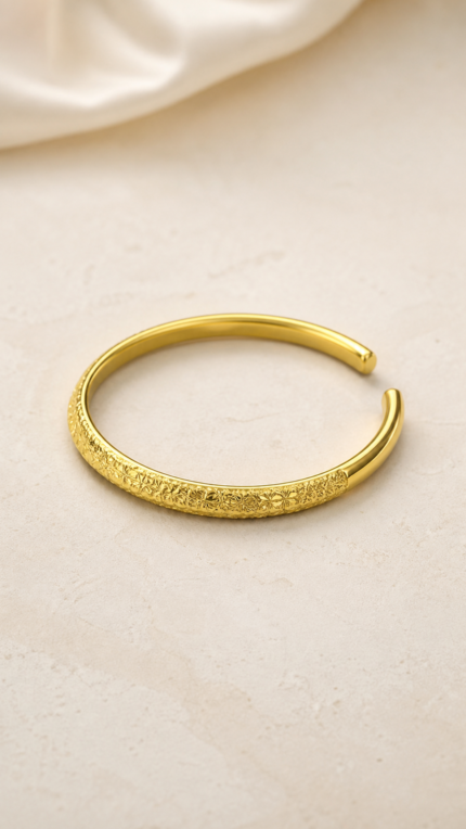 Aurone Sakura Crushed Ice Bangle lying naturally in a minimalist ivory scene