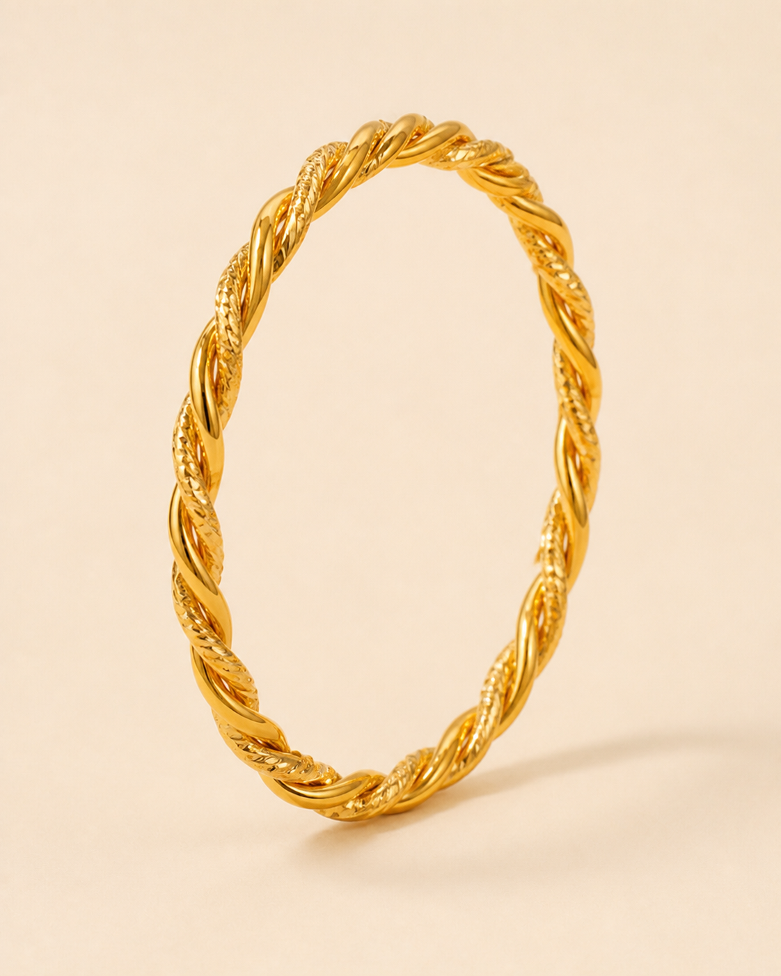 Marsa Twisted Bangle – Main product image Marsa Twisted Bangle golden jewelry product view